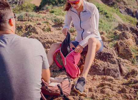 Happy young couple relax after climbs to the top of the mountains near the oceanの写真素材
