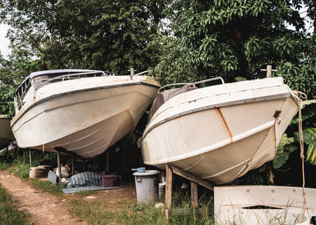 Old rustic boats being stored on dry landの写真素材