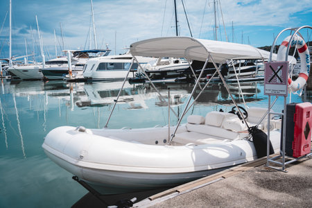 Many white modern yachts moored at the pier of marina.の写真素材