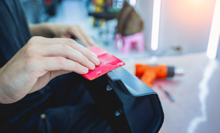 The process of installing protective film on the detail of a car.