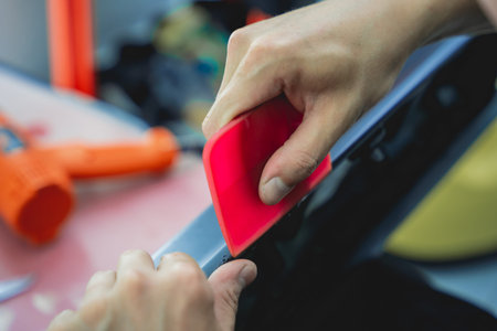 The process of installing protective film on the detail of a car.