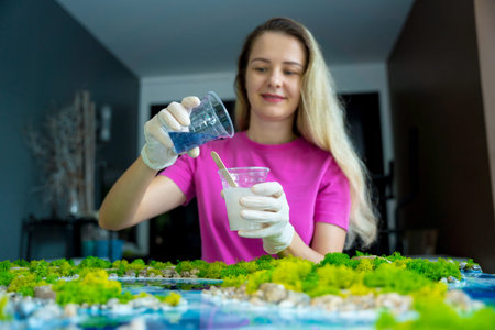 The process of making the art decor of epoxy resin, natural stones and moss