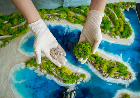 The process of making the art decor of epoxy resin, natural stones and moss