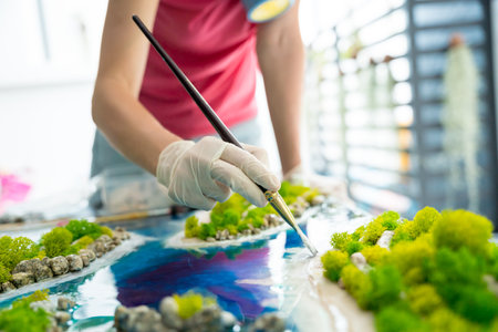 The process of making the art decor of epoxy resin, natural stones and mossの写真素材