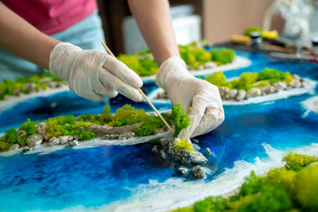 The process of making the art decor of epoxy resin, natural stones and moss