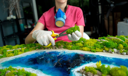 The process of making the art decor of epoxy resin, natural stones and moss