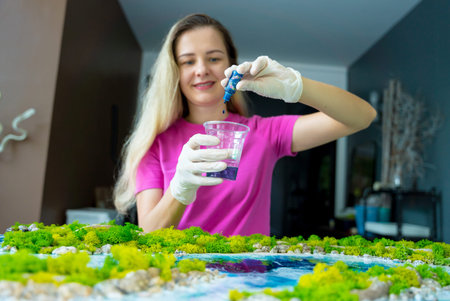 The process of making the art decor of epoxy resin, natural stones and moss