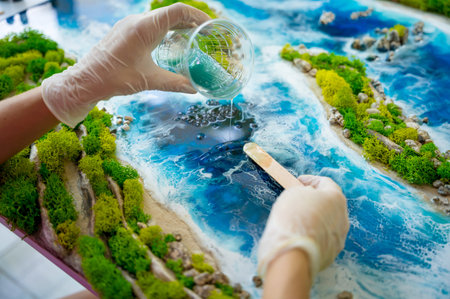 The process of making the art decor of epoxy resin, natural stones and moss