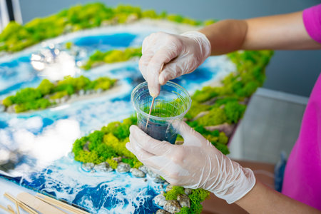 The process of making the art decor of epoxy resin, natural stones and mossの写真素材