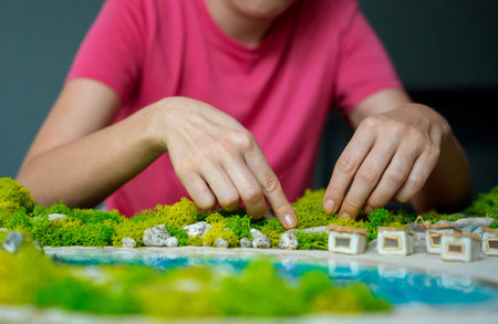 The process of making the art decor of epoxy resin, natural stones and moss