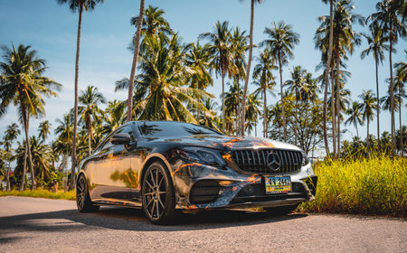 PHUKET, THAILAND- DECEMBER 24, 2023: Beautiful bright Mercedes AMG E53 against of nature with palmsのeditorial素材