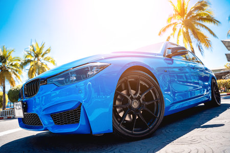 PHUKET, THAILAND- DECEMBER 25, 2023: Beautiful bright blue BMW M3 series in the parking lot.のeditorial素材