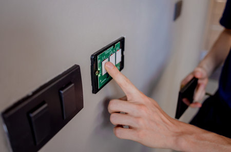 Technician installing sensor light switch at modern villa