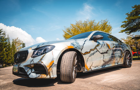 PHUKET, THAILAND- DECEMBER 24, 2023: Beautiful bright Mercedes AMG E53 against of nature with palmsのeditorial素材