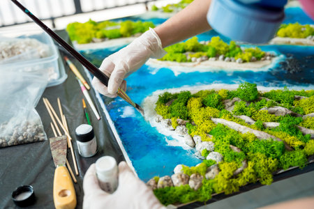 The process of making the art decor of epoxy resin, natural stones and moss