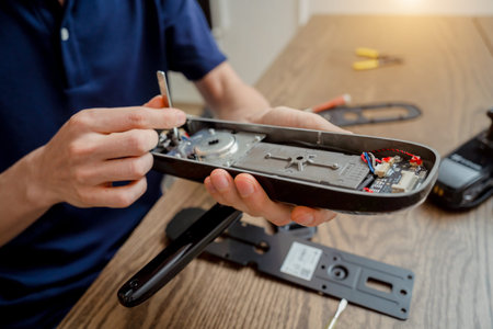 A technician assembles and installs smart electronic door lock for house protection