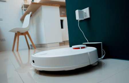 A robot vacuum cleaner at home moving towards the charging station.