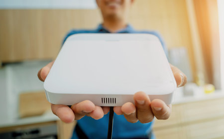 A technician installs a main unit security system in a modern apartment.