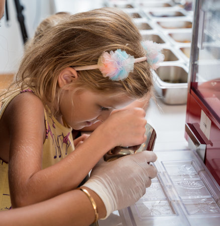 Baby girl in the workshop during a lesson on making handmade chocolates and sweetsの写真素材