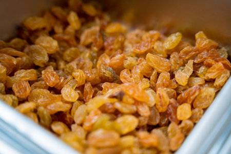 Nuts and dried fruits for making handmade chocolates and candies in a workshopの写真素材