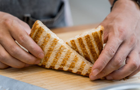 Chef cooking white bread toasted on an electric grill
