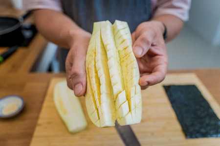 Chef at the kitchen preparing grilled eggplants with garlicの写真素材