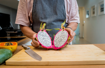 Chef cuts and peels dragon fruit on the cutting boardの写真素材