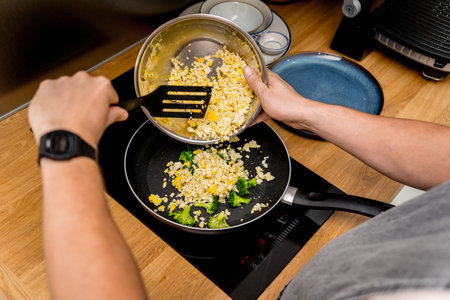 Chef at the kitchen preparing tofu scramble with vegetablesの写真素材