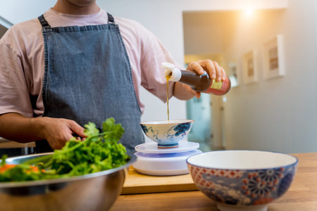 Chef at the kitchen preparing spicy glass noodle salad