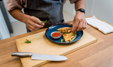 Chef at the kitchen preparing quesadillas with tofu and sweet cornの写真素材