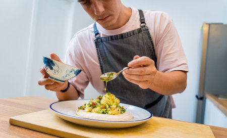 Chef at the kitchen preparing bean porridge with cauliflower and vegetables