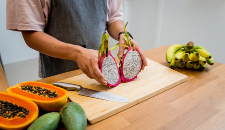 Chef cuts and peels dragon fruit on the cutting boardの写真素材
