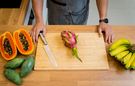 Chef cuts and peels dragon fruit on the cutting boardの写真素材