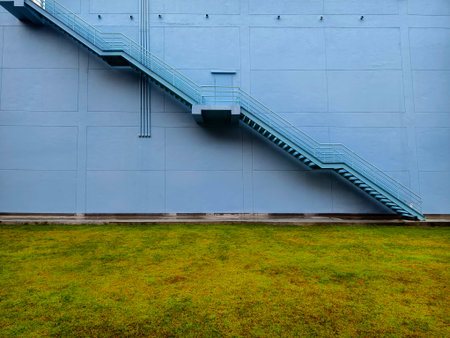A set of stairs ascending a large blue wallの写真素材