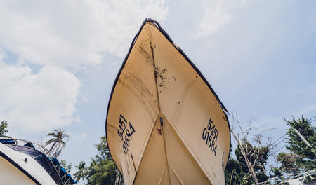 Old and rusty motor boats on a landfill surrounded by tropical forestの写真素材