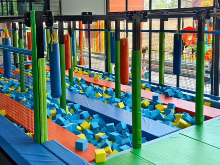 Trampoline park has blue and yellow foam cubes for kids fun