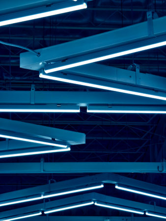 Ceiling with pipes is beautifully decorated with many industrial lampsの写真素材