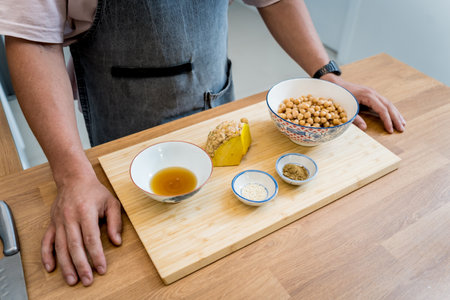 Cutting board with ingredients for preparing chickpea porridge with gingerの写真素材