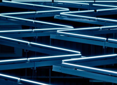 Ceiling with pipes is beautifully decorated with many industrial lampsの写真素材
