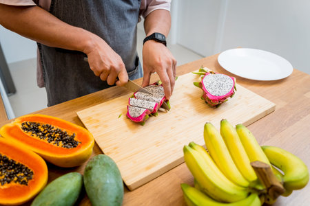 Chef cuts and peels dragon fruit on the cutting board