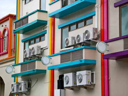 There are numerous air conditioners installed on the exterior of the building