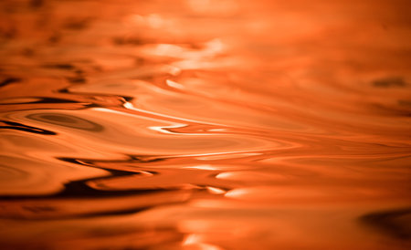A image of golden ocean waves featuring a water surface in detail