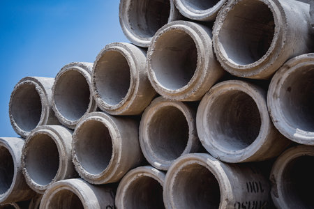 A stack of concrete ring pipes piled and creating a symmetrical arrangementの写真素材