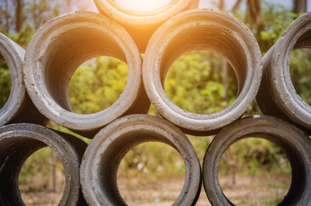 A stack of concrete ring pipes piled and creating a symmetrical arrangement