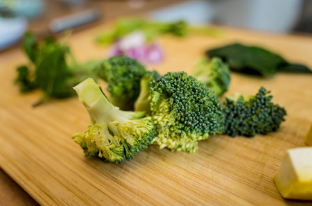 Cutting board with ingredients for preparing green curry with herbs and rice