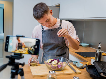 The chef is broadcasting live from workshop how to prepare a grilled eggplants with garlicの写真素材