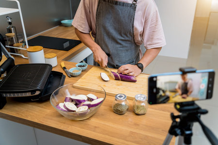 The chef is broadcasting live from workshop how to prepare a grilled eggplants with garlic