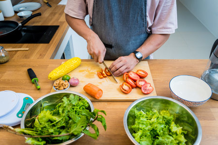 Chef at the kitchen preparing spicy glass noodle saladの写真素材