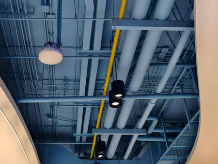 Ceiling with pipes and lights in creates industrial a patternの写真素材