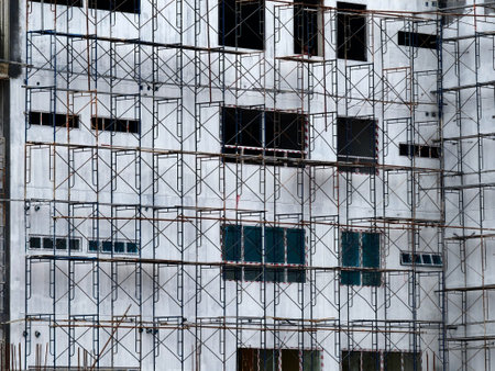 A tall building with numerous windows is being built